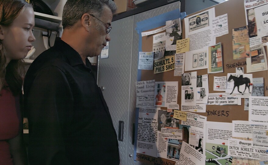 Father-daughter treasure hunters, Ross and Grace Getman, look at their board of clues outlining all of Dutch Schultz’s history.