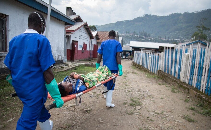 Medical workers transfer a patient from the Doctors Without Borders cholera treatment unit to the intensive care unit at the general hospital in Masisi, Democratic Republic of Congo.