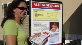 Liliana Osorio hands out information about the H1N1 virus at a Latino Health Fair in Escondido.