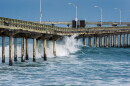 Waves crash under the Ocean Beach Pier on June 10, 2026.