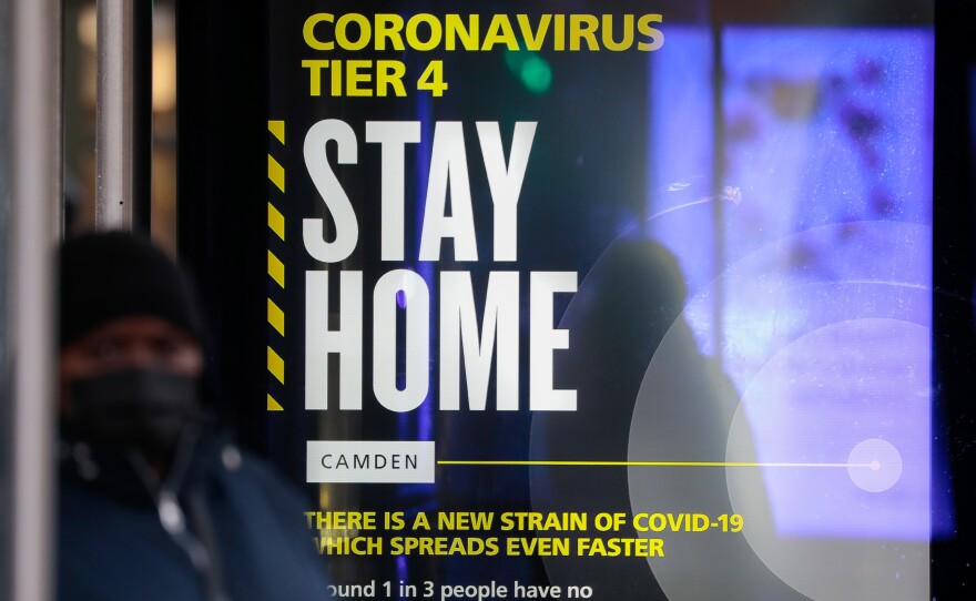 A poster about the new, fast-spreading variant of the novel coronavirus identified in the United Kingdom. The sign is displayed near King's Cross railway station in London.