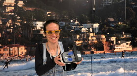 In this April 14, 2018 photo, Gwendolyn Barriac, an engineer at Qualcomm, proudly shows off her virtual reality goggles. Fun fact; the frames for her glasses are made from old records.

