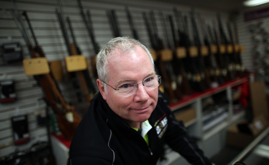 Karl Durkheimer, owner of Northwest Armory gun store in Portland, stands behind the counter Tuesday.