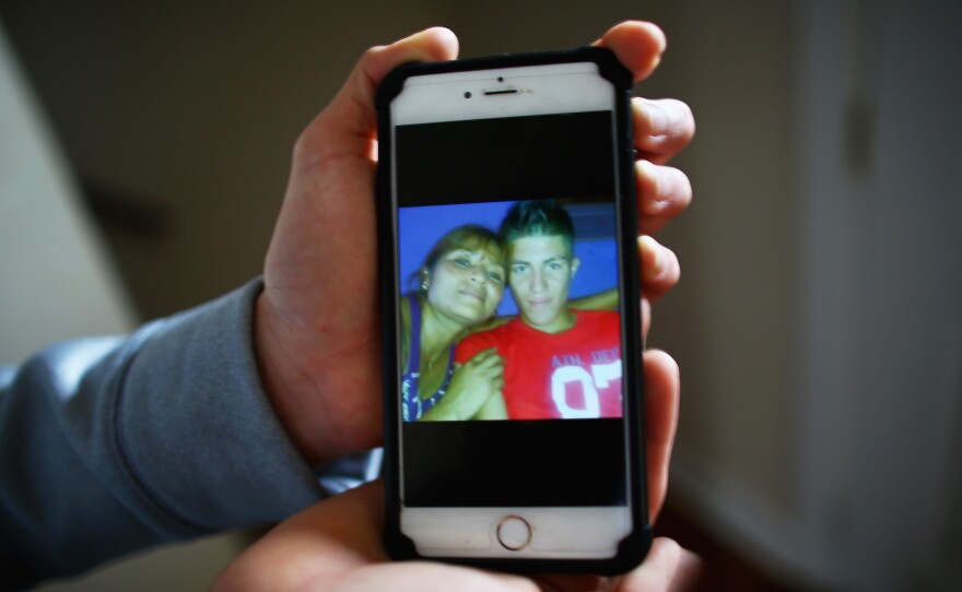 Trejo holds his phone with the last photo taken with his mother in El Salvador. He fled persecution from gang members in El Salvador. He says they assaulted him and stole from him and threatened to kill him, so he had no choice but to flee.