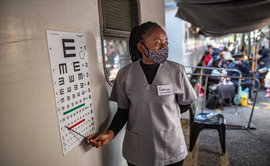 With a medical staff of 22, the Phelophepa train of South Africa provides health care to residents in need. Above: An optometry student carries out an eye test during a visit to the town of Kroonstad in South Africa's Free State province.