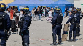 Police conduct a search operation at a makeshift camp of migrants who want to cross the English Channel to Britain near Dunkirk, northern France, Wednesday, May 27, 2026.