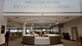 Construction workers finish the welcome desk for the renovated Escondido Public Library, July 14, 2026.