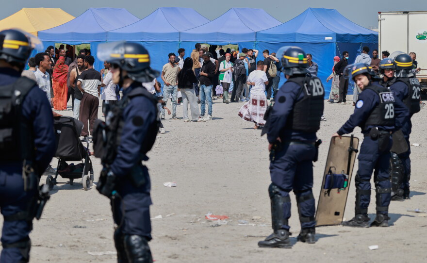 Police conduct a search operation at a makeshift camp of migrants who want to cross the English Channel to Britain near Dunkirk, northern France, Wednesday, May 27, 2026.