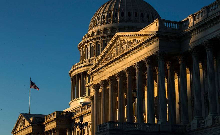 The U.S. Capitol building is illuminated by the rising sun, Wednesday, Dec. 18, 2019, on Capitol Hill in Washington.