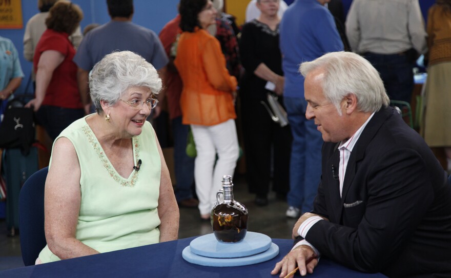David Rago (right) appraises an 1892 Rookwood spirit jug with silver overlay in San Jose, Calif. ANTIQUES ROADSHOW “Vintage San Jose, Hour 1” airs Monday, September 15 at 8/7C PM on PBS