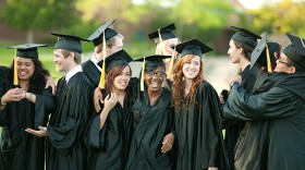 Students graduating with cap and gown.