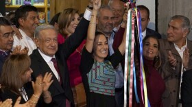 FILE - Mexican President Andres Manuel Lopez Obrador raises the hand of Claudia Sheinbaum, the ruling party's candidate for the upcoming presidential elections, during a ceremony to hand over the party's command staff, in Mexico City, Sept. 7, 2023. Mexico’s ruling party named its candidates for eight governorships and the mayor of Mexico City, on Saturday, Nov. 11, 2023, to compete in the country's June 2024 general elections. (AP Photo/Marco Ugarte, File)