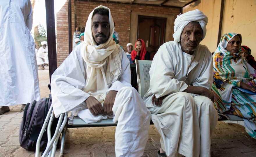 Mustafa Alnour Alhassan, 26, lost his leg to a flesh-eating fungal disease called mycetoma. Here, he sits beside his father, Albour Alhassan, at the Mycetoma Research Center in Khartoum, the capital of Sudan.