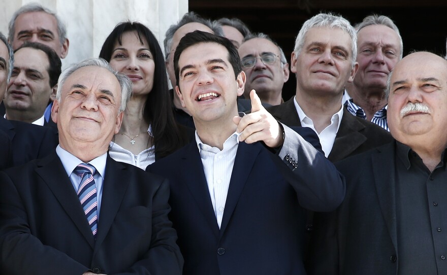 Greek Prime Minister Alexis Tsipras (center) gestures next to Deputy Prime Minister Yannis Dragasakis (left) and Interior and Administrative Reconstruction Minister Nikos Voutsis. Voutsis says Greece may miss its next debt payment.
