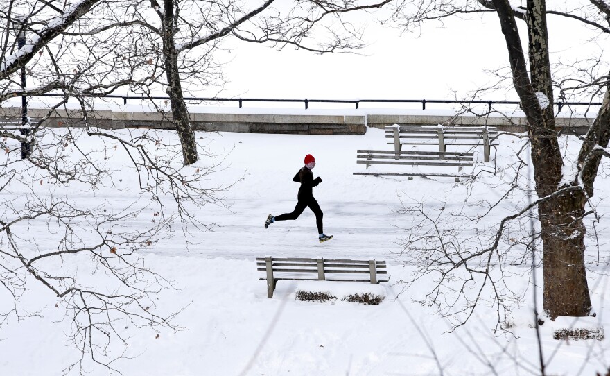 A man jogs through the snow in Riverside Park in upper Manhattan in New York City.