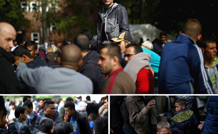 Refugees and migrants wait at the Regional Office for Health and Welfare in Berlin for food and a turn to start the paperwork to apply for asylum.