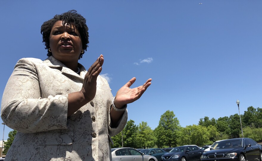 Stacey Abrams gives her supporters a pep talk at an early vote rally in DeKalb County, Ga.