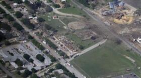 This Thursday, April 18, 2013 aerial photo shows the remains of a nursing home, left, apartment complex, center, and fertilizer plant, right, destroyed by an explosion in West, Texas. 