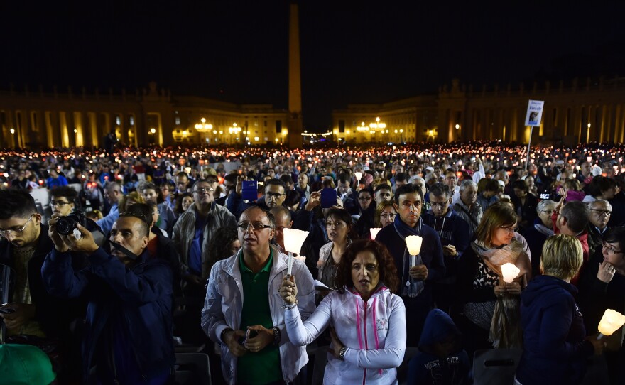 Faithful hold candles during a vigil prayer in preparation for the synod on the family on Oct. 4, at St. Peter's Square at the Vatican.