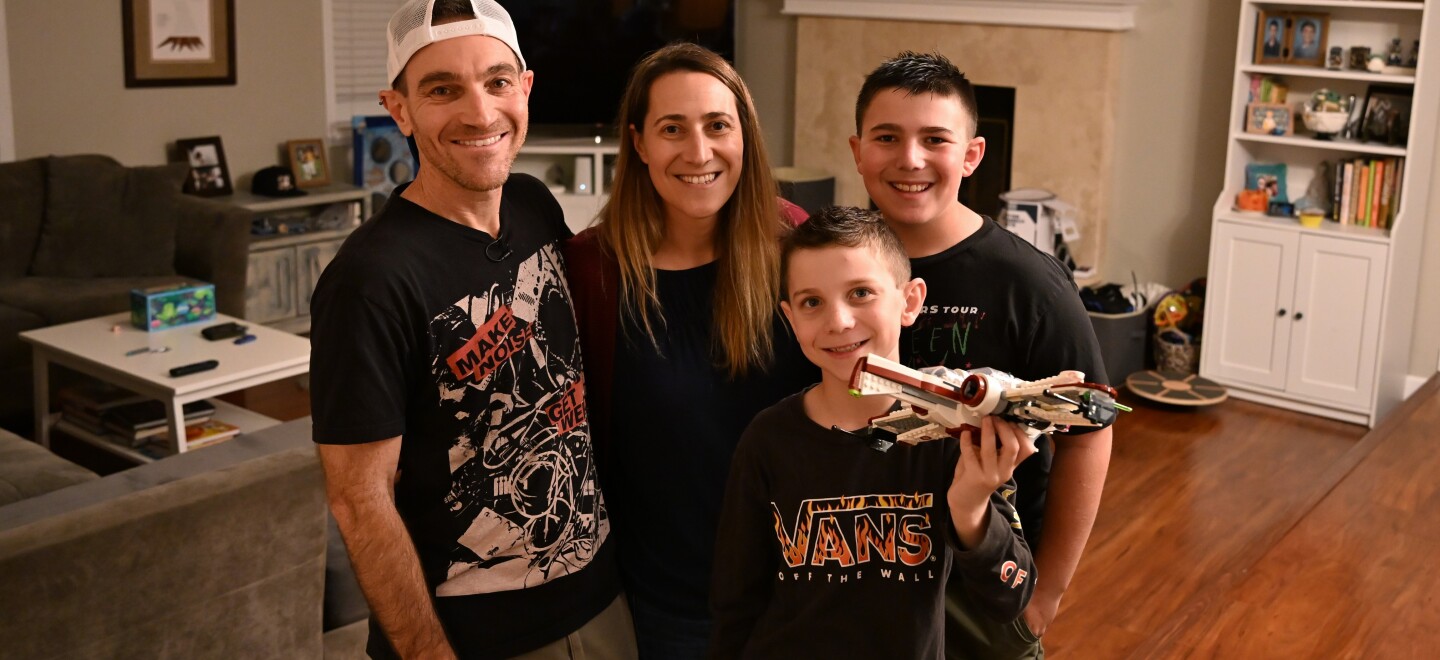 Evan Scheingross, Daniella Knelman and their kids, Riley, 11, and Kaleb, 8, pose for a post-haircut photo in their home on Thursday, Jan. 15, 2026.