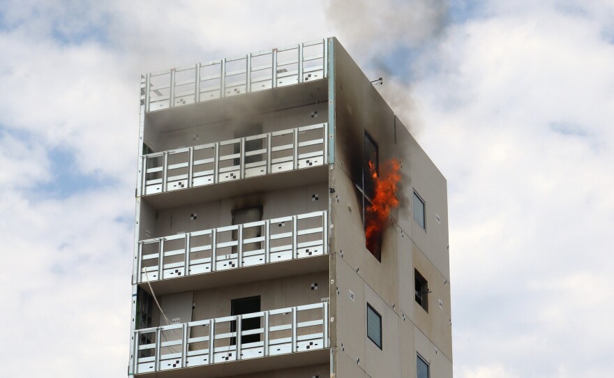 Smoke rises out of the ninth story of a cold-formed steel building on UC San Diego's shake table on Thursday, July 17, 2025.