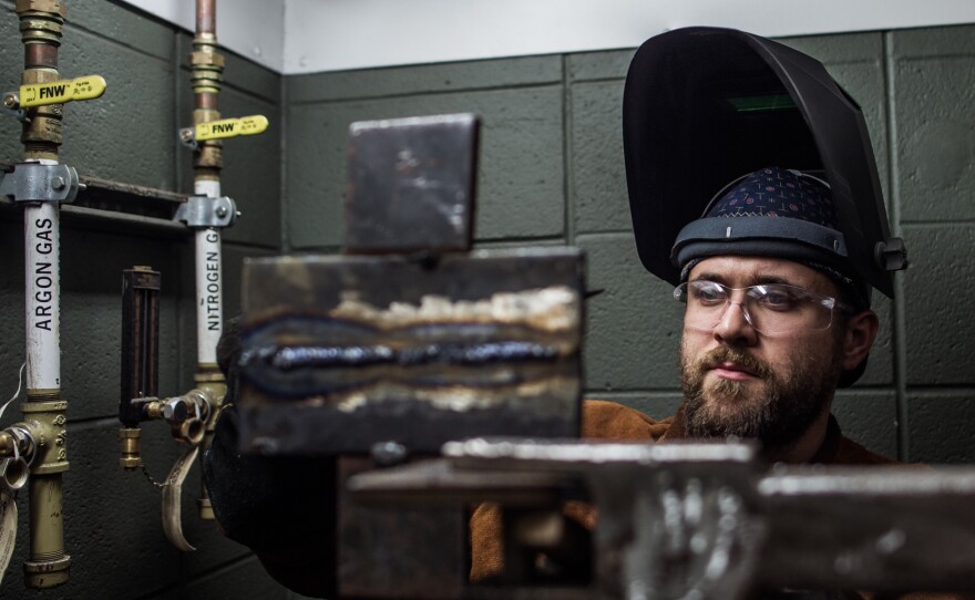 John Harris makes a weld for a test during a welding class at Spartanburg Community College in Spartanburg, S.C., on Oct. 22.