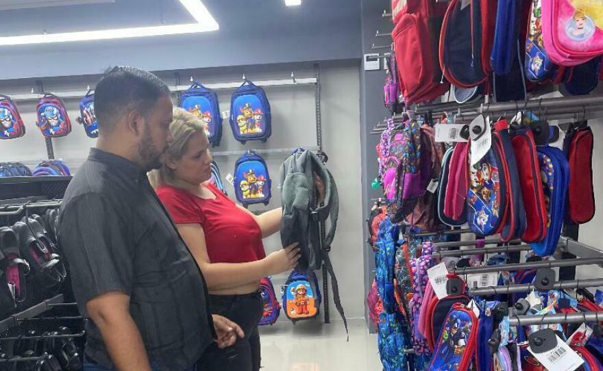 Ángel and Carolina Marín shop for backpacks of their son.