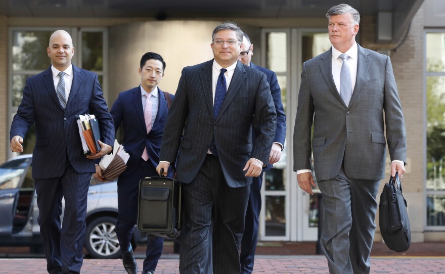 The defense team for Paul Manafort, including Kevin Downing (right) and Jay Nanavati (far left) walks into federal court on Thursday. After prosecutors rest, as they're expected to do Friday, the defense will have a chance to call witnesses and make its case.