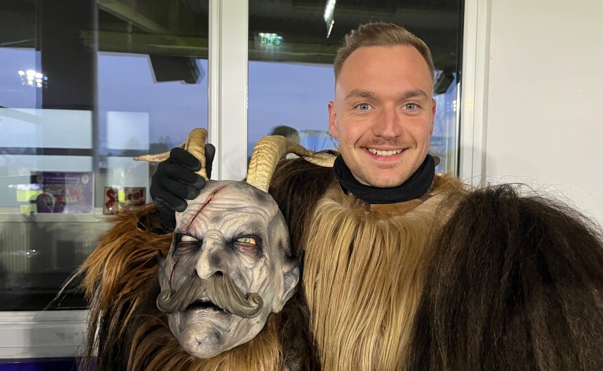 Roy Huber, from Bavaria, holds his Krampus mask prior to the Krampus Run. "When the winter comes, you get the feeling to be Krampus," he says.
