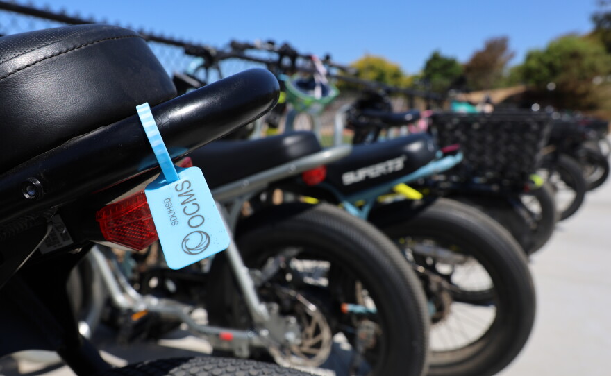 A bike tag from the San Dieguito Union High School District hangs from an e-bike outside a school on Aug. 21, 2026.