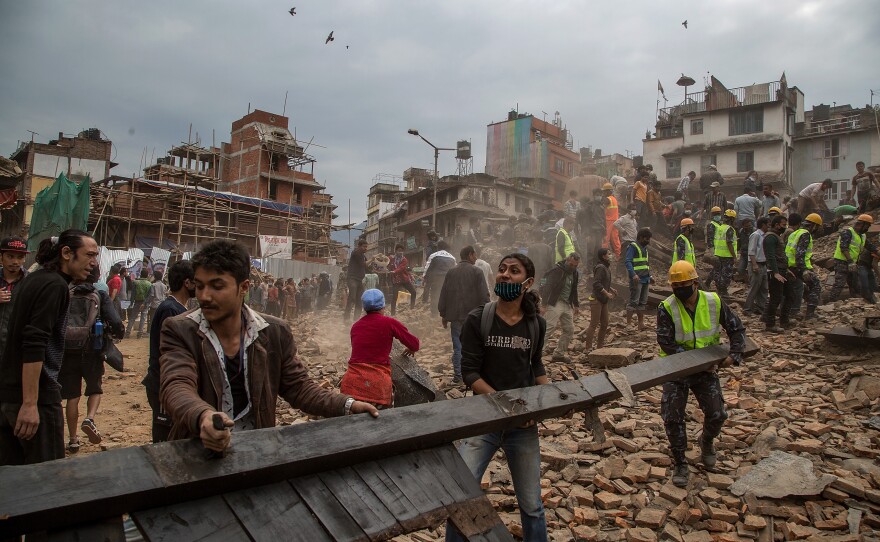 Emergency rescue workers clear debris in Basantapur Durbar Square while searching for survivors in Kathmandu, Nepal, Saturday.