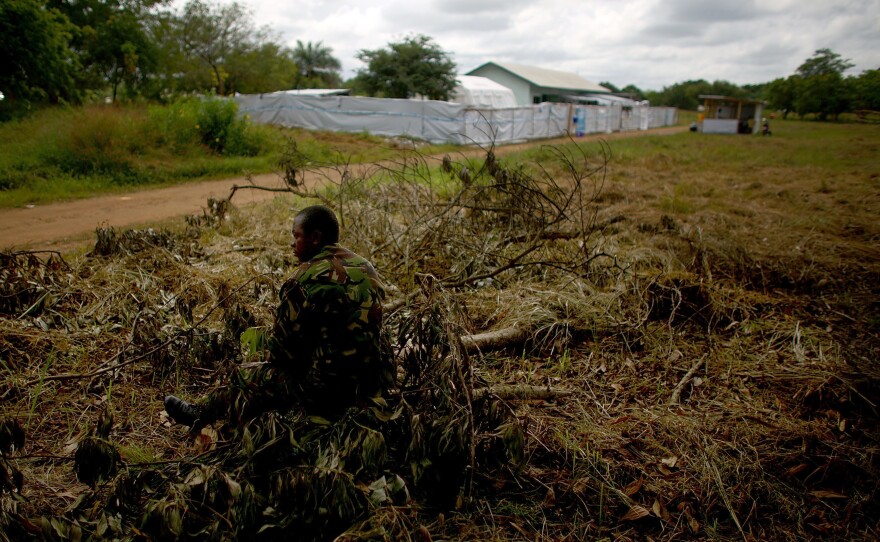 A soldier guards the road to the makeshift care center.