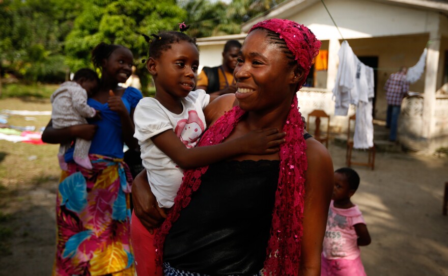 Makutu Jabateh hugs her daughter, Mabana Konneh, 5, as she returns to her community in Jacobstown, Monrovia.