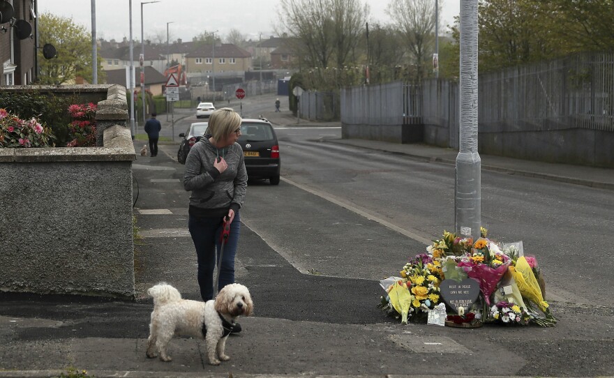 A woman stops to pay her respects Saturday at the scene where 29-year-old journalist Lyra McKee was fatally shot in Londonderry, Northern Ireland.