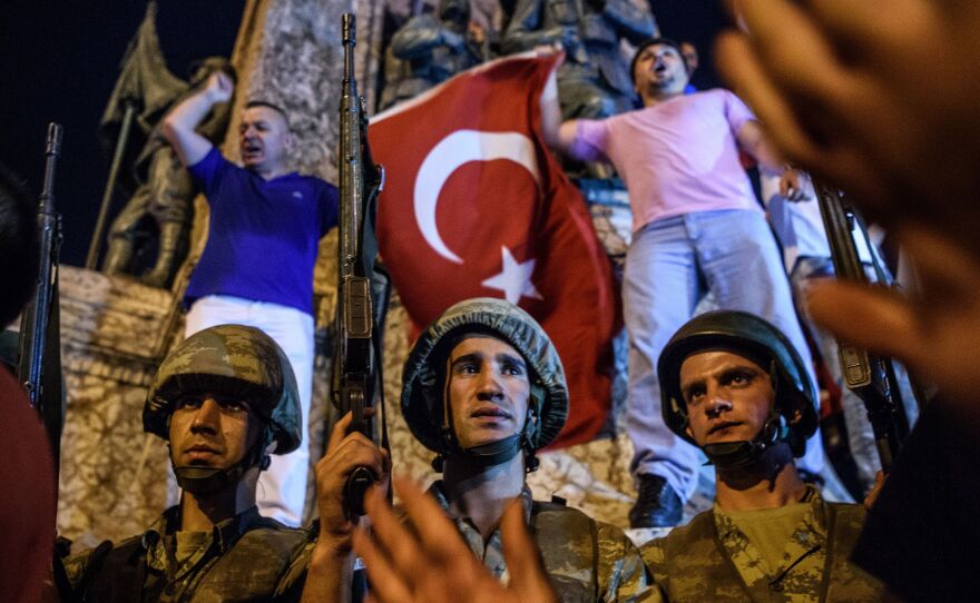 Turkish solders at Taksim square in Istanbul are surrounded by pro-government demonstrators early Saturday.