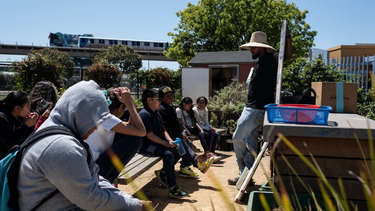 José Luis Rodriguez teaches fifth-grade students about gardening. Groups want more outdoor shade at schools on April 29, 2024 in Oakland, CA.