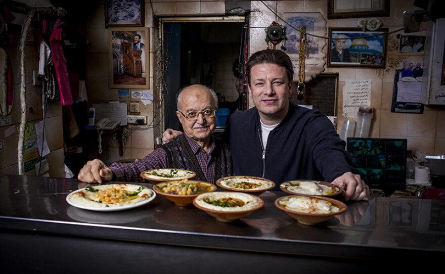 Host Jamie Oliver (right) learns about food cultures around the world that center vegetables.