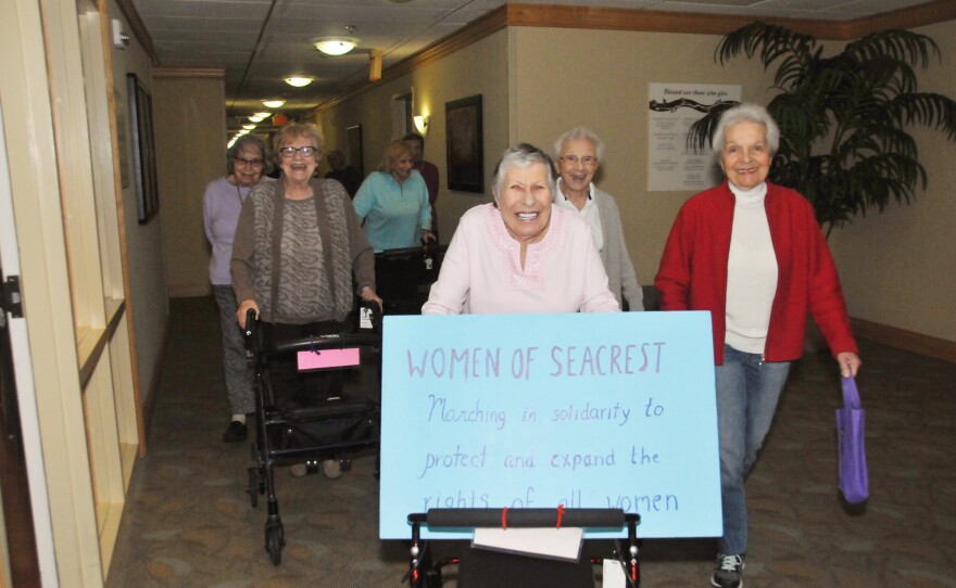 Women march down the halls at Seacrest Village retirement community in Encinitas, in solidarity with the national women's marches, January 21, 2017.