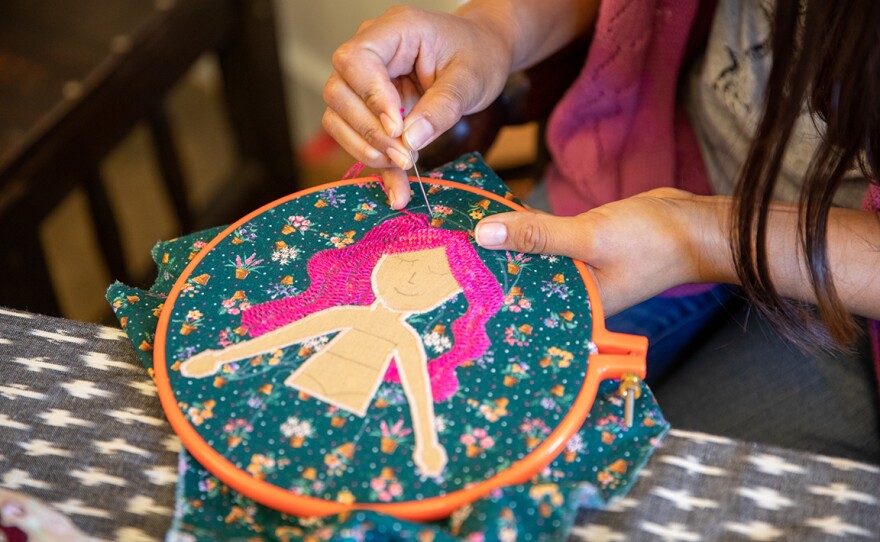 Mayra Camacho works on mermaid embroidery in an undated photograph