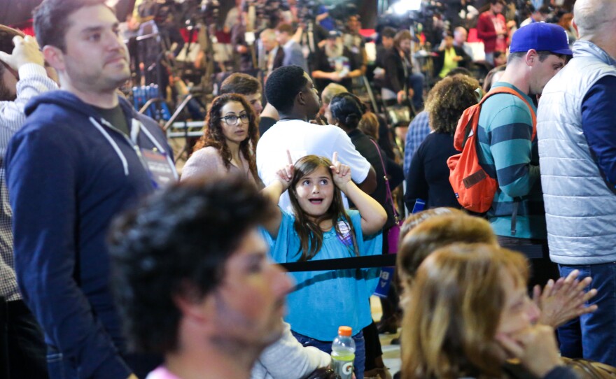 A young rally attendee playfully gestures as results from the California primary are displayed at Sanders' primary-night rally on June 7.