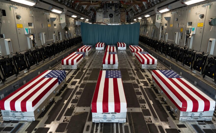 Flag-draped transfer cases line the inside of a C-17 Globemaster II, prior to a dignified transfer at Dover Air Force Base, Delaware. The fallen service members died while supporting non-combat operations in Kabul. Aug. 29, 2021.