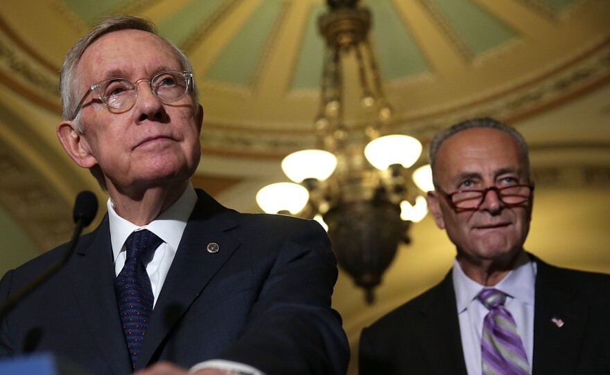 U.S. Senate Minority Leader Harry Reid, D-Nev., speaks to members of the media Sept. 9 at the Capitol. Reid is retiring after this Congress; he'll be succeeded as minority leader by Sen. Charles Schumer, D-N.Y. (right).
