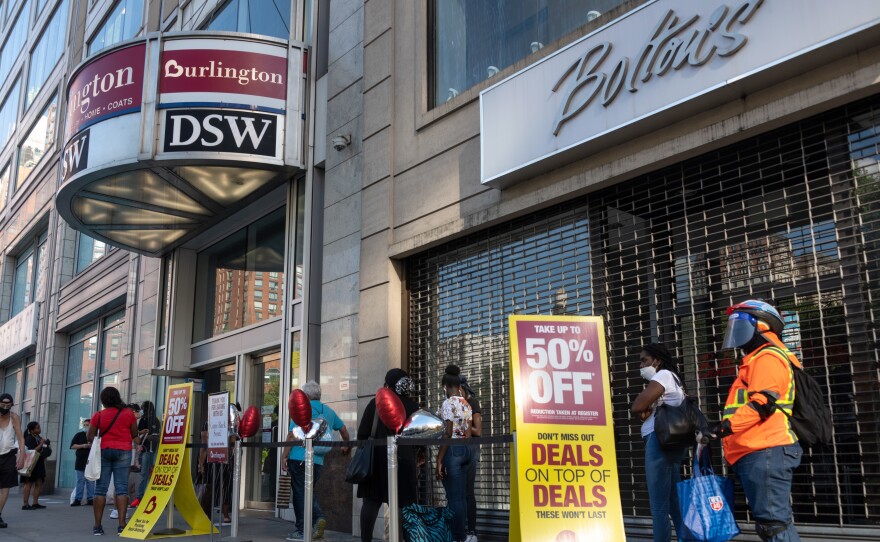 Shoppers line up near sale signs at a Burlington store in New York in June.