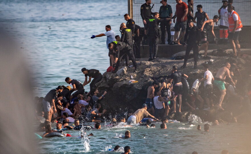 Migrants try to cross from Morocco into the Spanish enclave of Ceuta, Thursday, July 30, 2026.