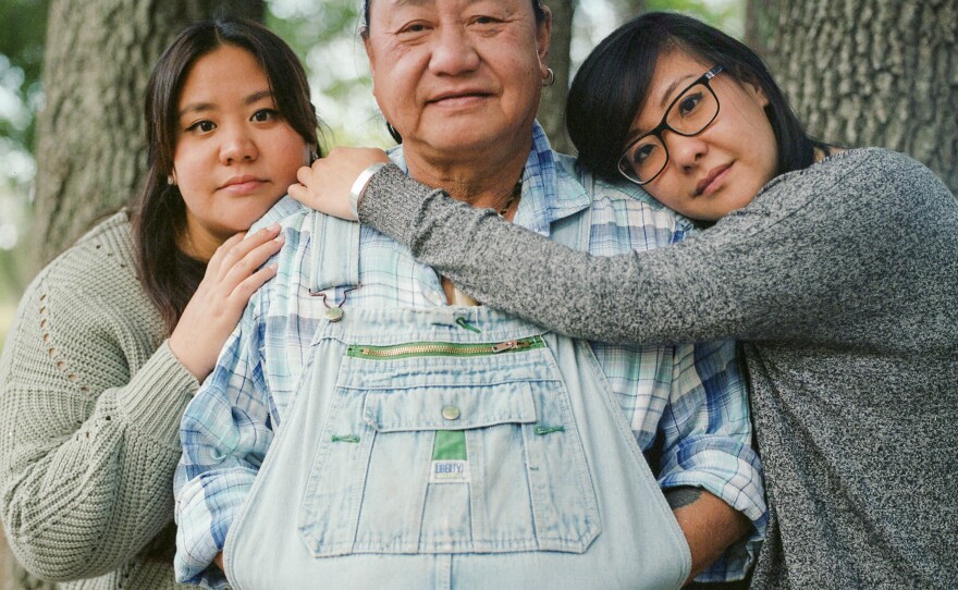 Marlon Chen, and his two daughters Victoria and Linda Chen, stand for a portrait. Marlon Chen immigrated to the United States in the 1980s from Taiwan and now runs a bonsai and rock shop off a state highway outside of Austin.