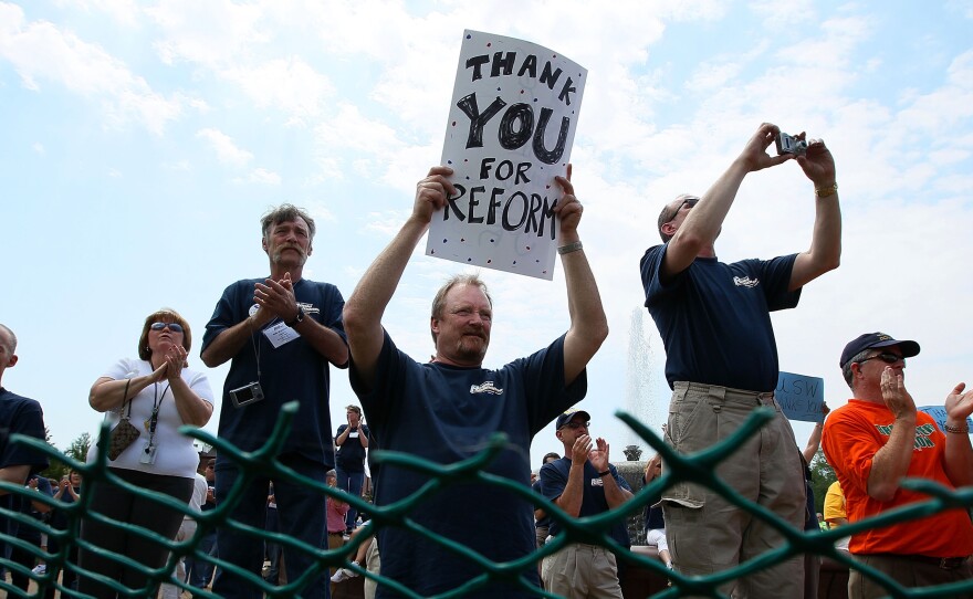 Union member Tom Stensberg holds a sign thanking Congress for the Affordable Care Act during a rally hosted by the AFL-CIO at the U.S. Capitol in May 2010.