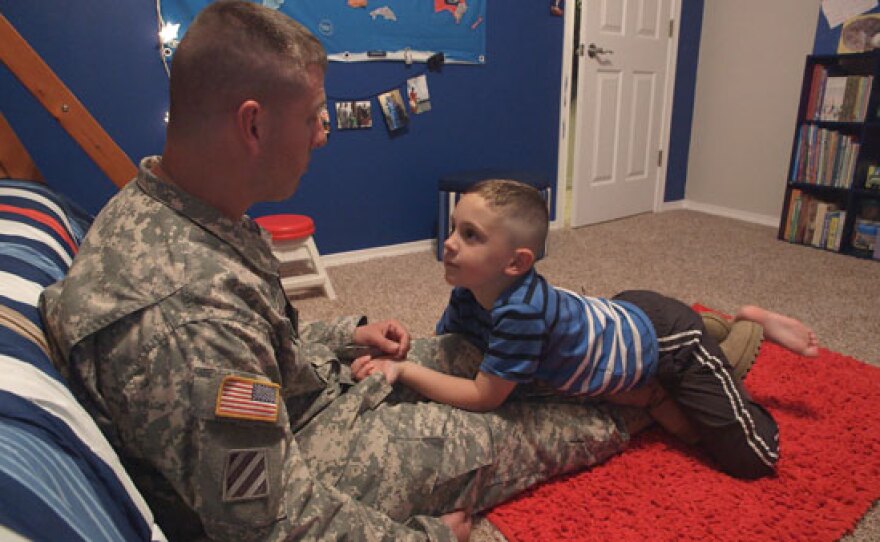 Army Staff Sergeant Leo Gruba talks to his son LJ about his upcoming deployment.