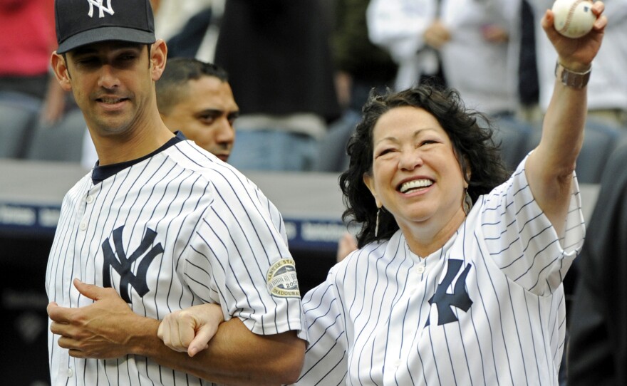 Sotomayor is escorted onto the field by New York Yankees catcher Jorge Posada to throw out the ceremonial first pitch before the New York Yankees game against the Boston Red Sox at Yankee Stadium on Sept. 26, 2009.