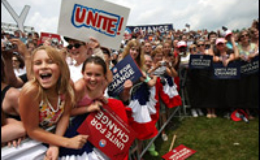 The crowd cheers as Illinois Sen. Barack Obama and New York Sen. Hillary Rodham Clinton enter the town of Unity, N.H.