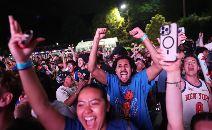 New York Knicks fans celebrate during a watch party inside Central Park during Game 4 of the NBA Finals basketball series between the Knicks and the San Antonio Spurs, Wednesday, June 10, 2026, in New York.